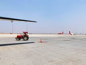 Bicycles on airport runway against clear sky