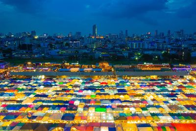 High angle view of illuminated buildings in city at dusk