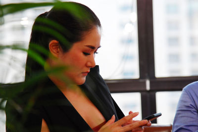 Portrait of young woman using mobile phone