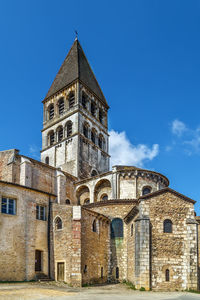 Low angle view of old building against blue sky