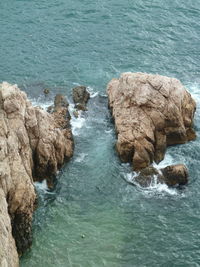 High angle view of rocks on sea