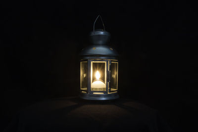 Close-up of illuminated light bulb in darkroom