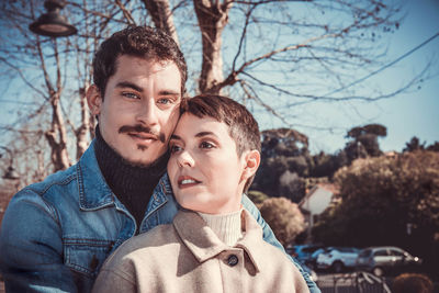 Portrait of a young couple who is walking at the bracciano lake in italy. love concept.