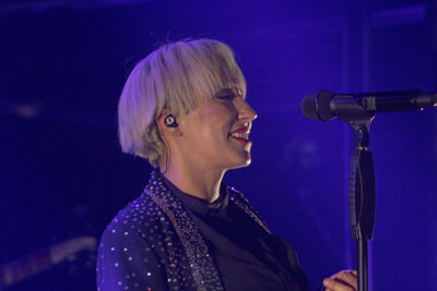 Portrait of teenage boy playing at music concert