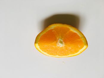 Close-up of orange fruit against white background