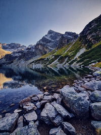 Scenic view of lake and mountains against clear sky