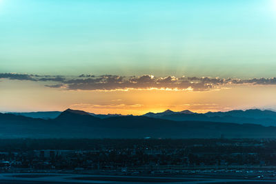 Scenic view of silhouette mountains against sky at sunset