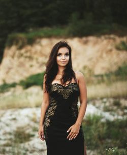 Portrait of young woman standing outdoors