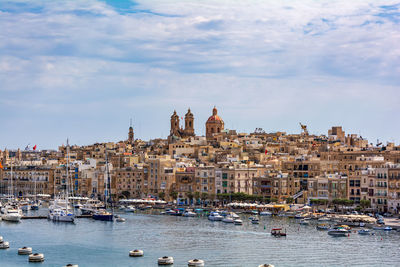 Cityscape of senglea, and yachts in harbour between cities birgu and senglea, malta.