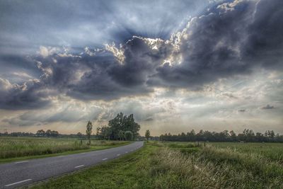 Scenic view of landscape against cloudy sky