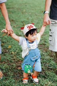 Full length of father and son on field