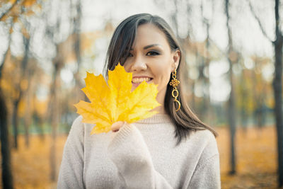 Close-up of young woman holding flower