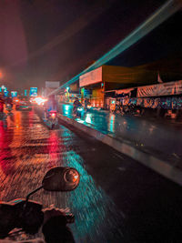 Illuminated city street at night