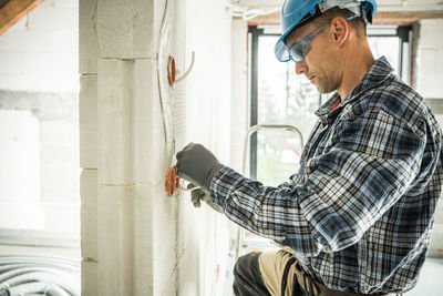 Side view of man working at home