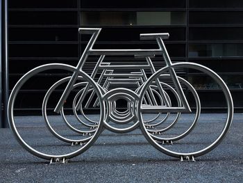 Bicycle rack against building in city