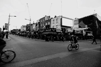 Man riding bicycle on road in city