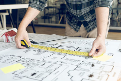 Midsection of man working on table