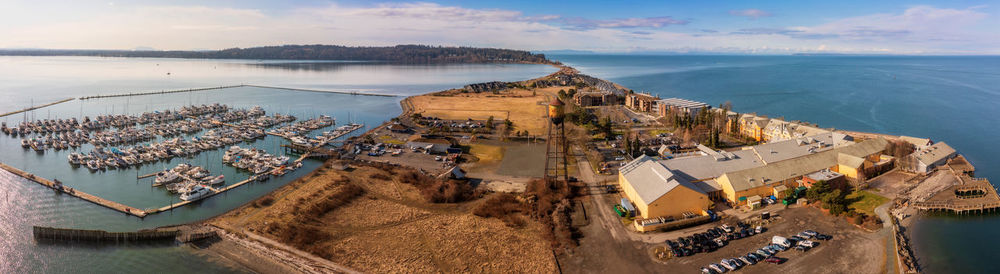 High angle view of townscape by sea against sky