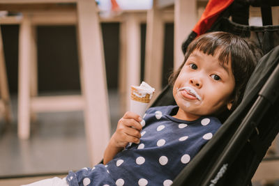 Portrait of boy holding ice cream outdoors