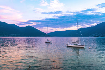 Lake locarno with sailing boats and mountains in the background sunset