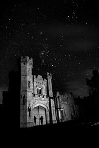 Low angle view of illuminated buildings against sky at night