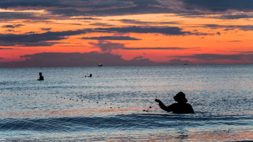 A fisherman is fishing at sunset on koh rong, cambodia