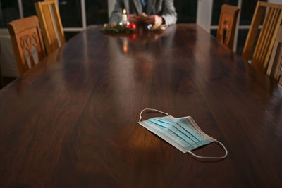 Midsection of man eating food sitting at home