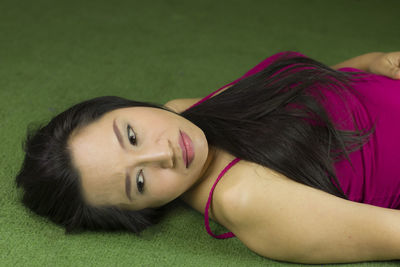 Portrait of smiling woman lying down