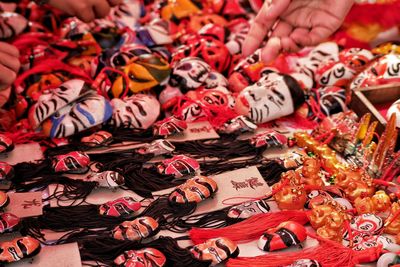 Cropped hands of people buying souvenirs at market