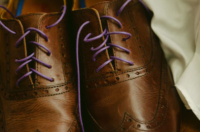 Close-up of shoes hanging on wood