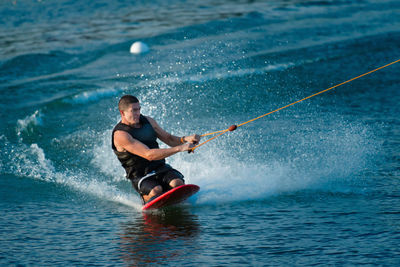 Mid adult man kiteboarding on sea