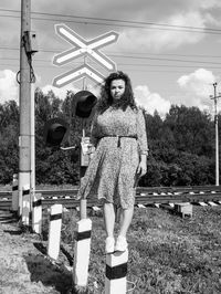 Portrait of woman standing against built structure