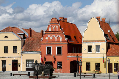 Buildings in town against sky