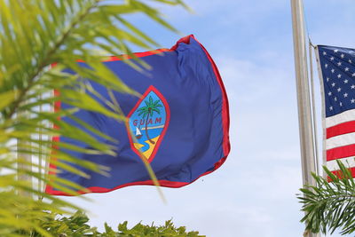 Low angle view of flags hanging against sky