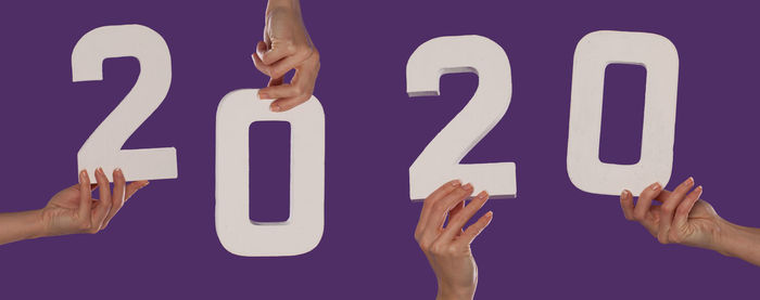 Low section of woman holding text against gray background