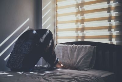 Man relaxing on bed at home