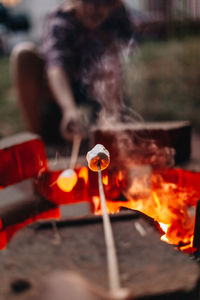 Close-up of hand holding lit candles