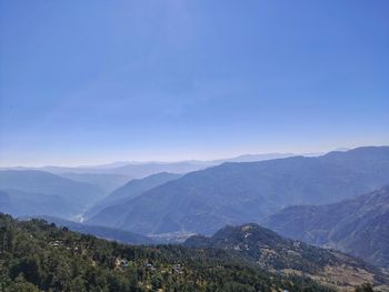 Scenic view of mountains against clear blue sky