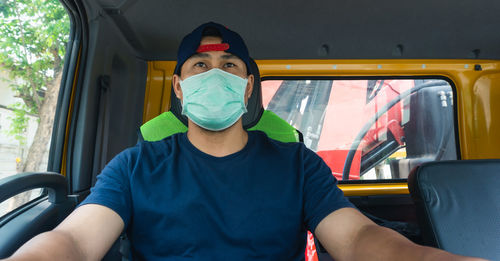 Portrait of man sitting in car