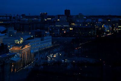 Aerial view of city lit up at night