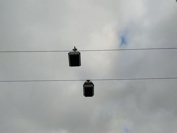 Low angle view of telephone pole against sky