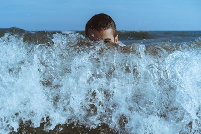 Portrait of boy swimming in sea