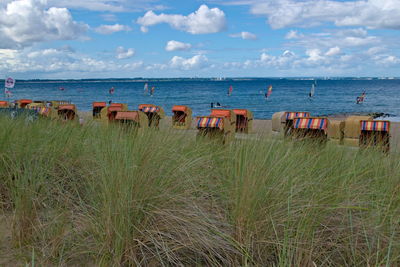 Grass with hooded beach chair overlooking water