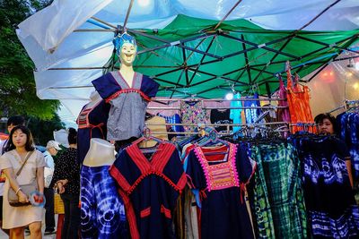 Multi colored umbrellas hanging for sale at market stall