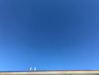 Low angle view of building against clear blue sky