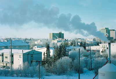 Houses in city against sky