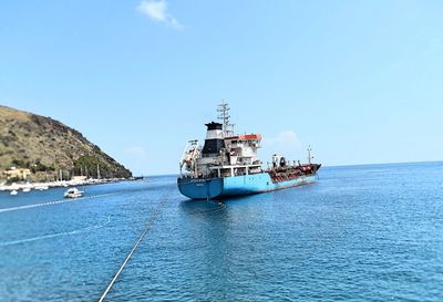 Ship sailing in sea against clear sky