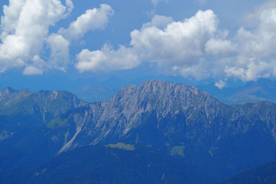 Scenic view of snowcapped mountains against cloudy sky