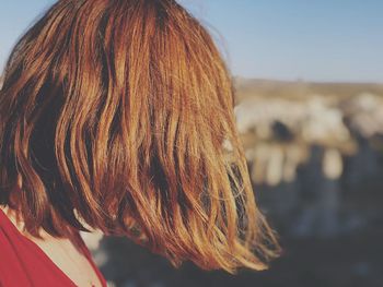 Close-up of redhead woman in city