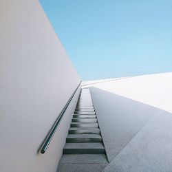 Low angle view of staircase against clear blue sky